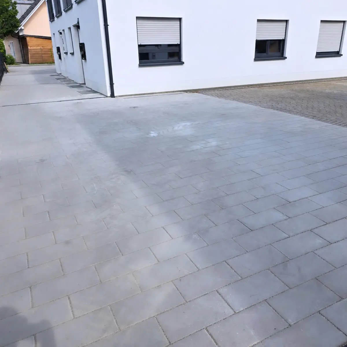 Gepflasterte Hoffläche und Hofeinfahrt am Wohnhaus in München-Aubing